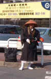 A ZEN-BUDDHIST MONK BEGGING OUTSIDE SUMO ARENA, TOKYO by Kris